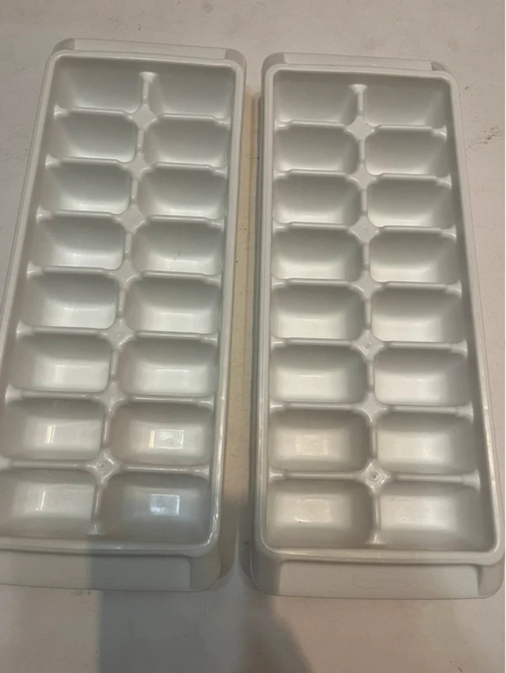 2 plastic ice cube containers